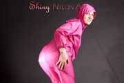 Mara wearing a sexy pink rainsuit posing infront of the camera in a studio (Pics)