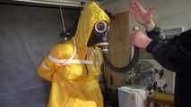 Watch Lady M bound in a yellow Rainsuit wearing a latex Hood and a Gasmask