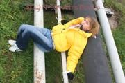Leonie tied and gagged outdoor wearing a shiny yellow downjacket (Pics)