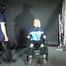 Alice bound and gagged in a nylon Rainsuit on a wheelchair with mouth stuffed and multilayergag