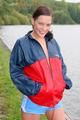 Sexy archive girl walking on a lake wearing a sexy shiny nylon shorts and an oldschool rain jacket (Pics)