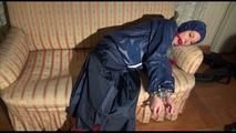 Mara tied, gagged and hooded on an old sofa wearing a cool blue rain skirt and a jacket as well as rubber boots (Video)