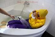 Julia tied and gagged in a ski suit in the bath tub
