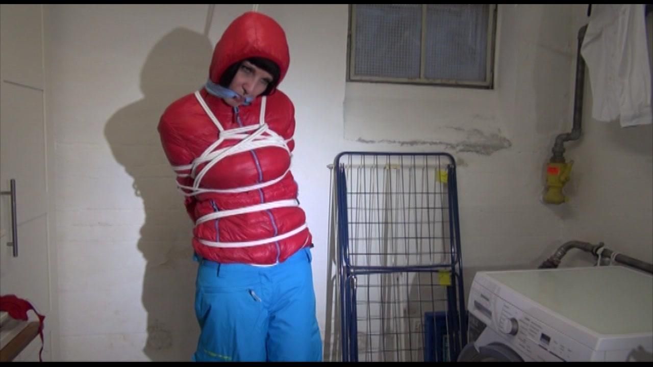 Mara Tied, Gagged And Hooded In A Laundry Wearing A Sexy Blue Down Pants And A Red Down Jacket (Video)