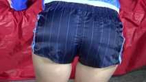Watching sexy Sonja wearing a supersexy oldschool blue shiny nylon shorts and a lightblue rain jacket during her workout with barbells (Video)