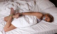 Barefoot Dolly is getting overpowered, bound and gagged on the bed on-screen