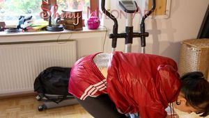 Mara wearing a red shiny nylon shorts, a black shiny leggins and a red rain jacket doing her workout (Pics)