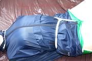 Jill tied, gagged and hooded in bed wearing a sexy green shiny nylon shorts and a shiny rain jacket (Video)