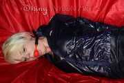 Sexy Courtney being tied and gagged with ropes and a ballgag on a bed wearing dark blue rainwear (Pics)