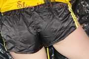 Lucy wearing a sexy black/yellow shiny nylon shorts and a yellow rain jacket preparing her sofa with a special cloth to enjoy it (Pics)