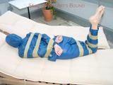 Beautiful archive girl in a blue shiny nylon rainsuit tied and gagged with tape on a sunlounger (Pics)