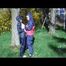Jill and a friend of her playing with eachother in the garden while wearing shiny nylon rainwear (Video)