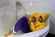 Julia tied and gagged in a ski suit in the bath tub