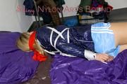 Samantha tied and gagged wearing a beautiful lightblue nylon shorts and a darkblue rain jacket (Pics)
