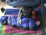 02:45 Min. video with a girl tied and gagged in a skisuit and a big shiny nylon bag to lie in from our archive