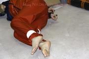 Shelly tied and gagged in shiny nylon rainwear
