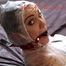 Jill tied, gagged and hooded on bed wearing a shiny transparent PVC coat and a pink panty (Pics)