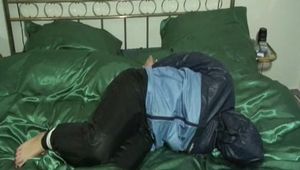 Two videos of our archive girls tied and gagged in shiny nylon rainwear