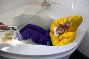 Julia tied and gagged in a ski suit in the bath tub