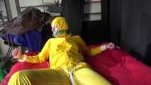 Watching sexy Pia being tied and gagged with ropes on a bed and a clothgag wearing sexy yellow shiny nylon rainwear (Video)