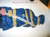 One of our archive girls bound and gagged in a blue shiny rainsuit 