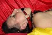 SEXY MARA ties and gagges herself with cuffs and a ball gag wearing a sexy red/yellow shiny nylon shorts and a sexy yellow top (Pics)