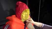 Watching Jill wearing a sexy shiny nylon rain pants and three shiny nylon rain jackets and a life jacket being tied and gagged and HOODED three times (Video)