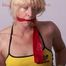 Pia tied and gagged on bed wearing a red shiny nylon shorts with yellow stripes and a retro shirt (Pics)