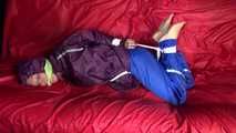 SANDRA being tied and gagged on a sofa with ropes and a clothgag wearing a sexy blue shiny nylon rain pants and a purple rain jacket  (Video)