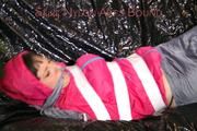 Mara tied, gagged and hooded with tape on a sexy black covered sofa wearing a supersexy grey rain pants and a pink rain jacket (Pics)