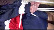 ***HOT HOT HOT*** PIA tied and gagged on a bed with ropes on the ceiling wearing sexy blue/red shiny nylon shorts and a white shirt (Video)