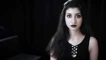 Goth girl with black eyes occasionally prefers dragging a 120mm cigarette