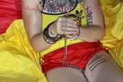 SEXY MARA ties and gagges herself with cuffs and a ball gag wearing a sexy red/yellow shiny nylon shorts and a sexy yellow top (Pics)