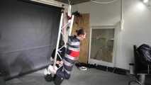 Marie taped and suspended in shiny nylon Rainwear