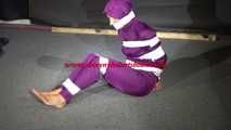 Sexy Sandra wearing a supersexy purple shiny nylon rainsuit bein tied and gagged and hooded on the floor with tape (Video)