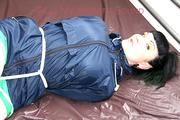 Jill tied, gagged and hooded in bed wearing a sexy green shiny nylon shorts and a shiny rain jacket (Video)