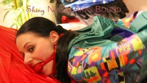 Lucy tied and gagged on bed wearing a sexy green rainwear combination (Pics)