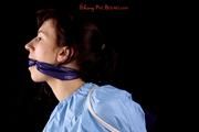 Julia tied and gagged in a shiny PVC suit