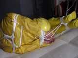Watch Pia enjoying Bondage in her shiny nylon yellow Rainwear