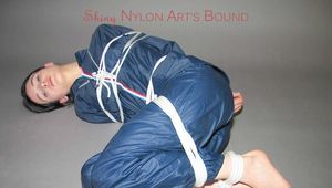 Beautiful slim archive girl tied and gagged in a swhiny blue rainwear on the floor (Pics)