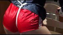 Sonja tied and gagged on a chair wearing a sexy red shorts and an oldschool rain jacket (Video)