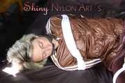 Watching sexy Sonja being tied and gagged on a bed with ropes and a clothgag wearing a supersexy shiny brown nylon pants and a brown rain jacket (Pics)