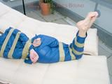 Beautiful archive girl in a blue shiny nylon rainsuit tied and gagged with tape on a sunlounger (Pics)