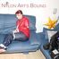Jill tied, gagged and hooded infront of a sofa wearing a darkblue rain pants and a red rain jacket (Pics)