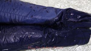 Nina tied and gagged in a shiny nylon down jacket and rainpants