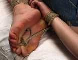 Doris hogtied on bed