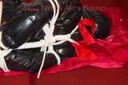 Lucy wearing a black shiny nylon rainh pants and a black down jacket tied and gagged on a sofa (Pics)