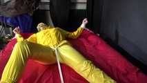 Watching sexy Pia being tied and gagged with ropes on a bed and a clothgag wearing sexy yellow shiny nylon rainwear (Video)
