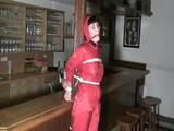 one of our archive girl tied and gagged in a shiny nylon rainsuit