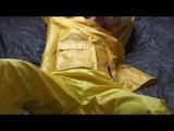 Pia tied and gagged in an yellow rainsuit on bed (Video)
